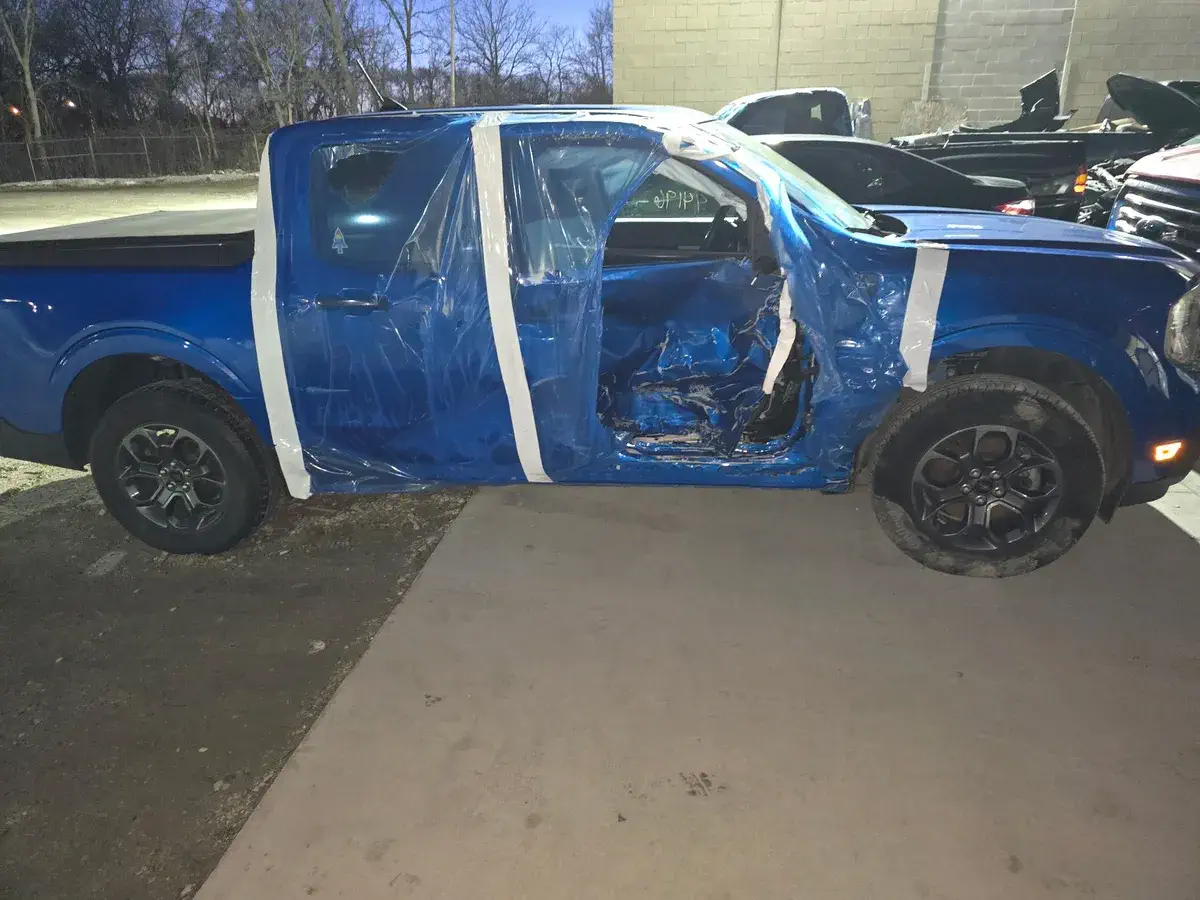 Almost totalled blue truck before repair at Angel Auto Repair