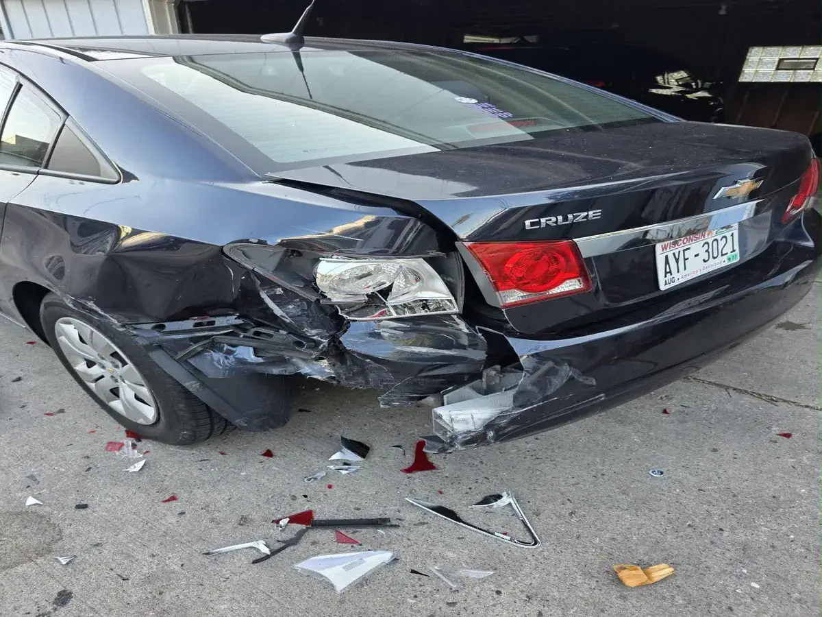 Black car with rear end damage before repair