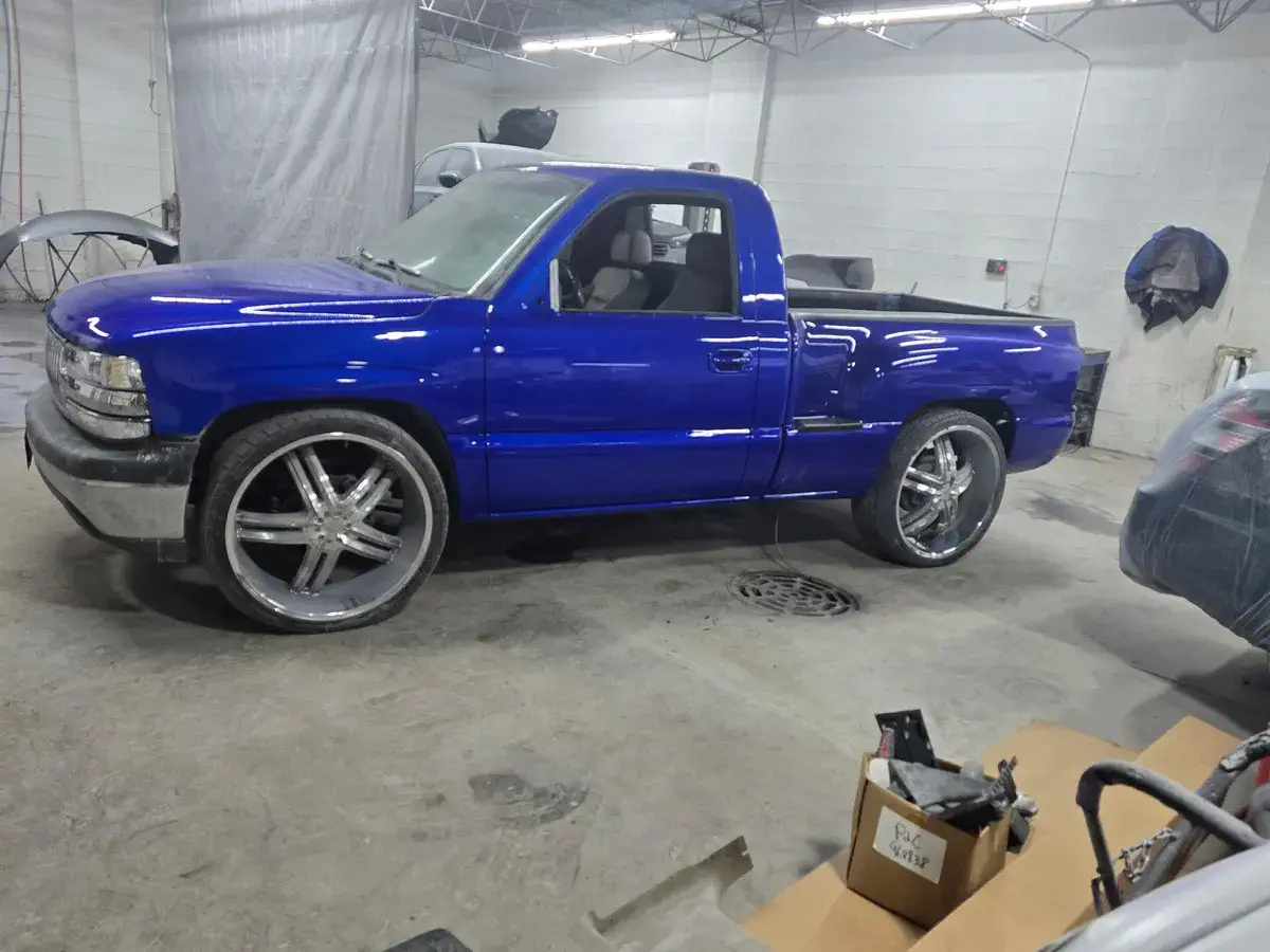 Blue truck with new rims after repair at Angel Auto Repair