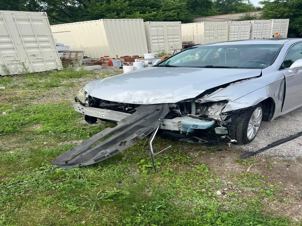 Front of a gray car before trunk and body repair