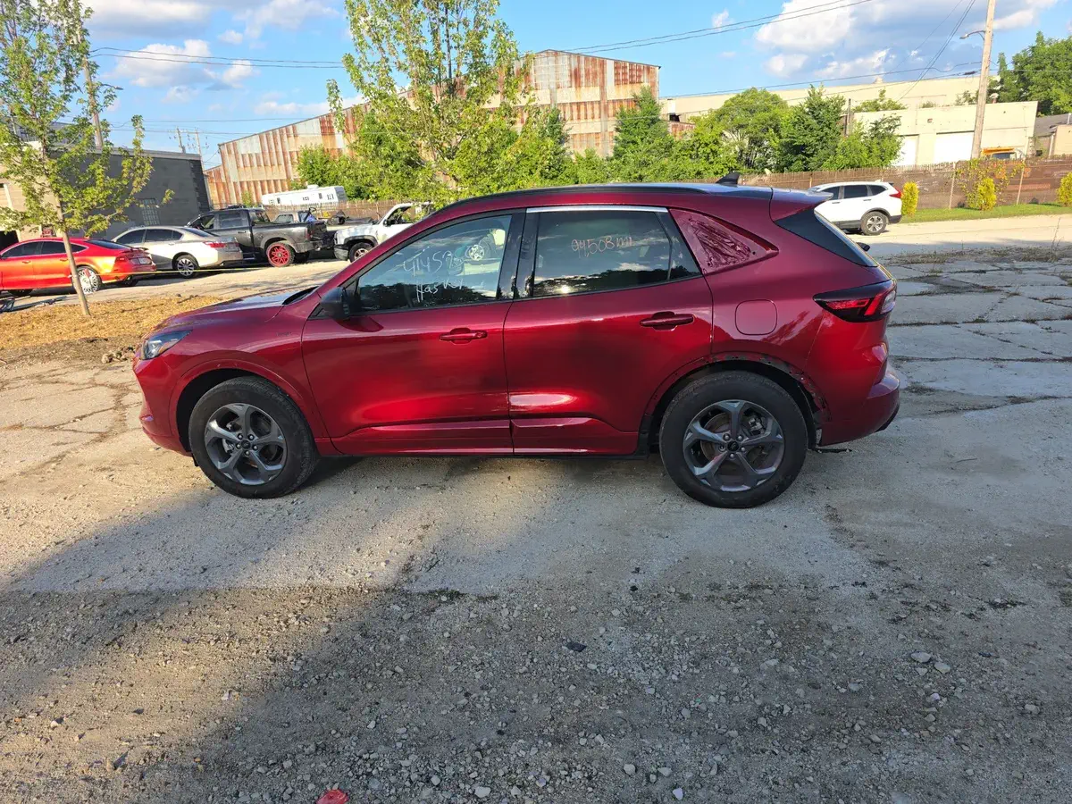 Red SUV passenger door after repair at the shop