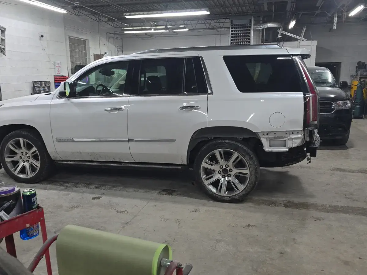 White Escalade with trunk damage before repair